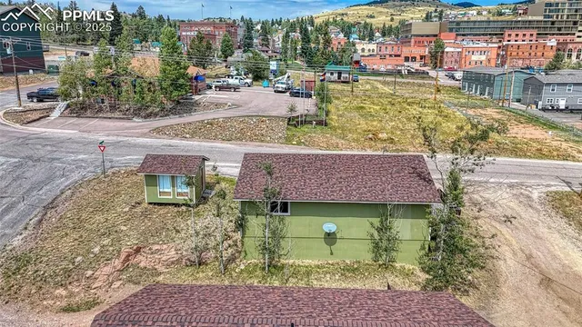 a view of roof deck with dining table and chairs