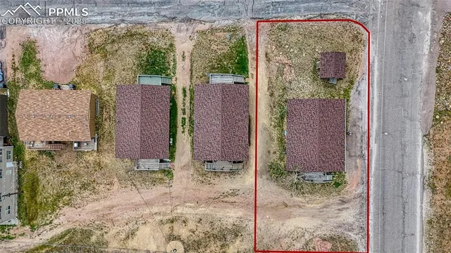 a view of a brick wall next to a yard