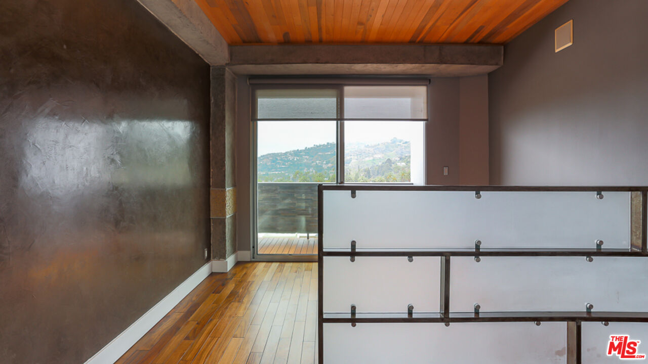 7250 Franklin Avenue, Unit 1112 Los Angeles, CA 90046 - Photo 14 of 29 a view of a room with wooden floor and windows
