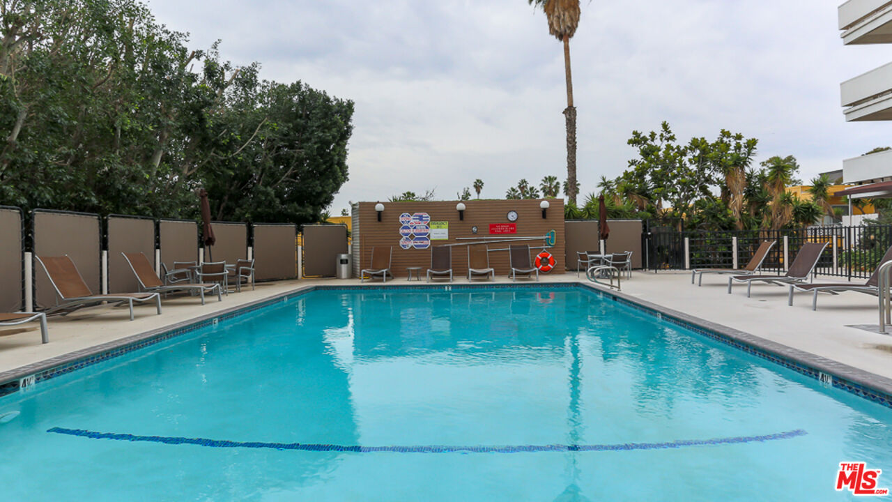 7250 Franklin Avenue, Unit 1112 Los Angeles, CA 90046 - Photo 18 of 29 a swimming pool with outdoor seating and yard