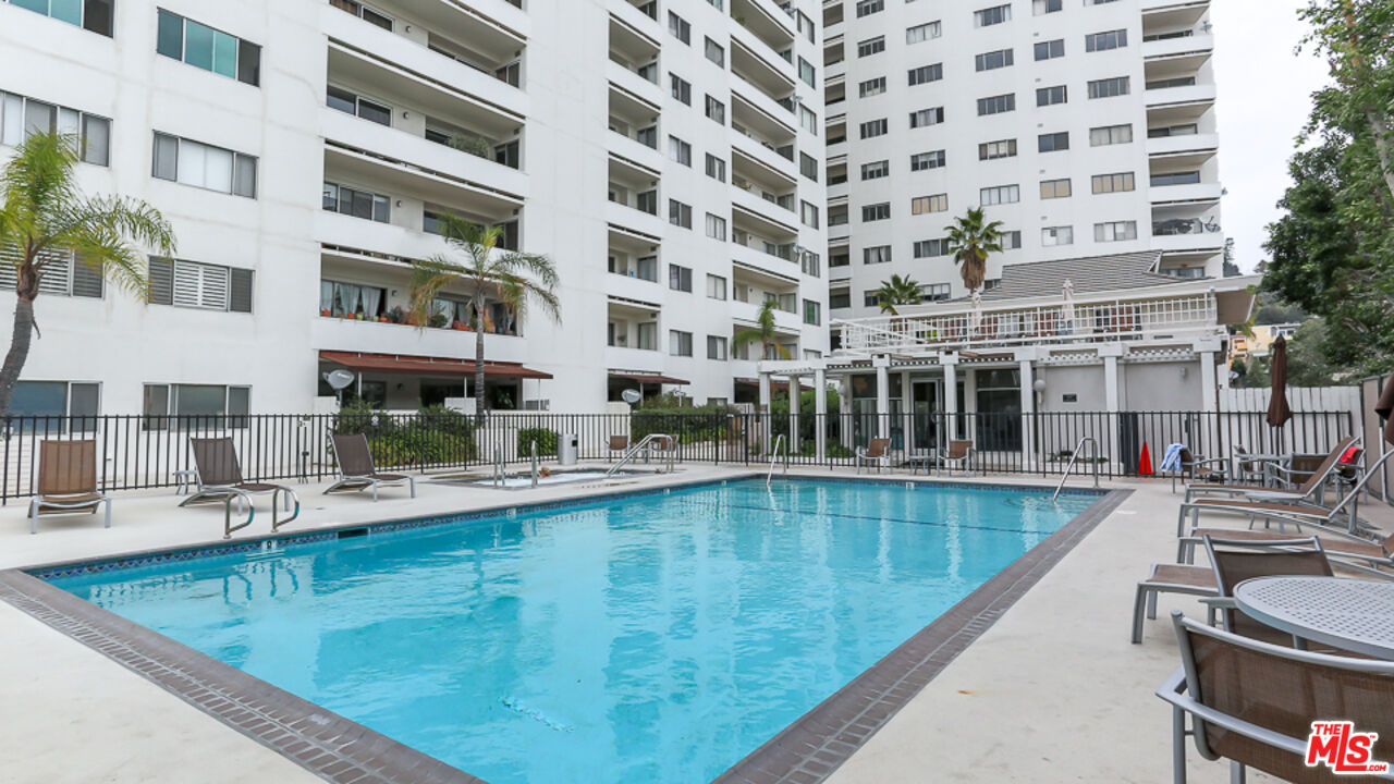 7250 Franklin Avenue, Unit 1112 Los Angeles, CA 90046 - Photo 19 of 29 a view of a swimming pool with a lounge chairs