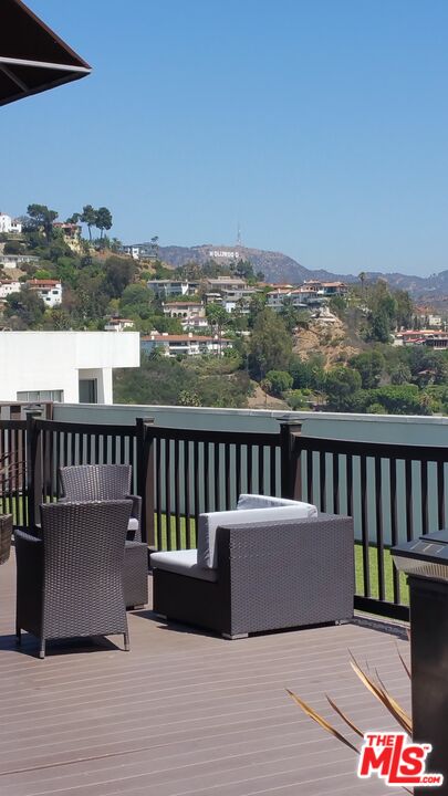 7250 Franklin Avenue, Unit 1112 Los Angeles, CA 90046 - Photo 26 of 29 a view of a balcony with wooden floor and city view
