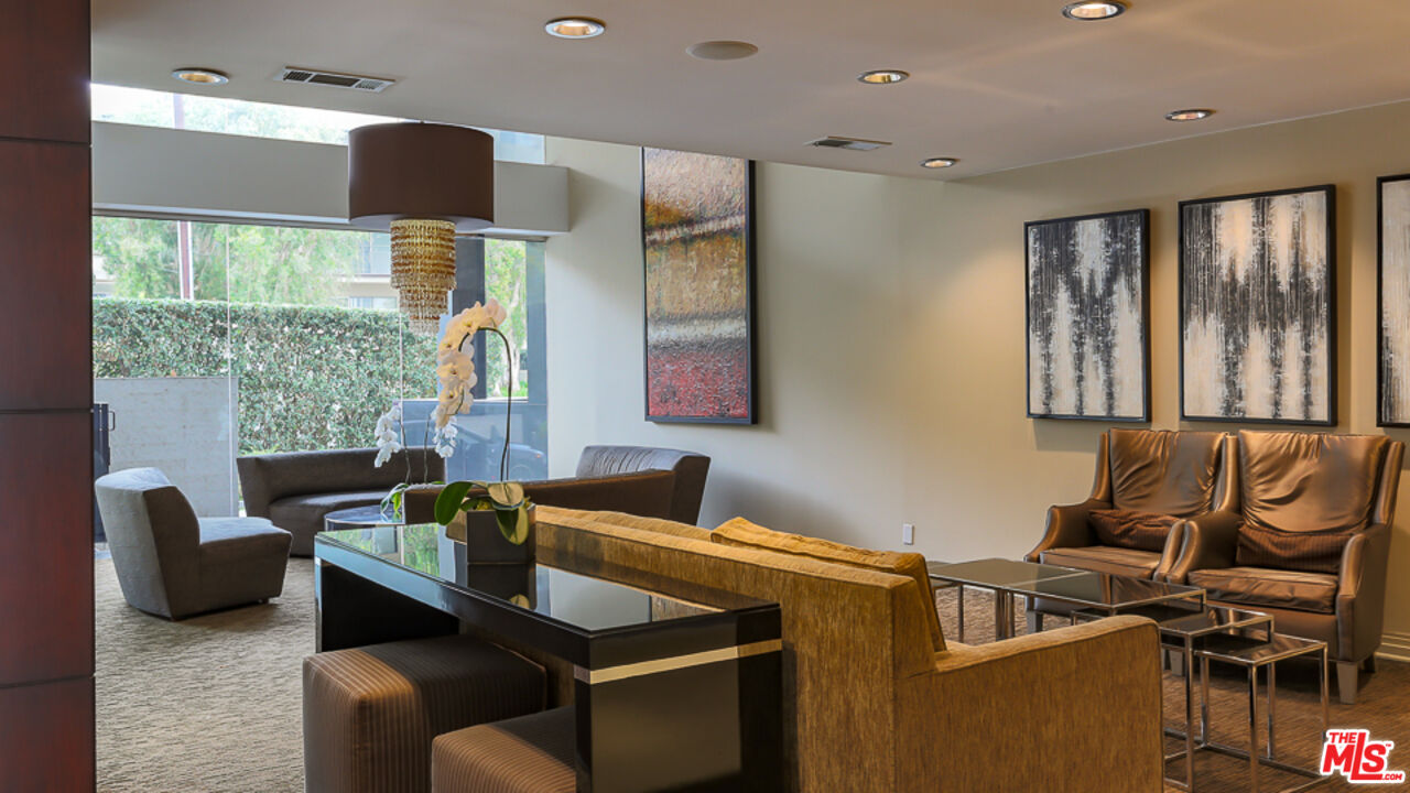 7250 Franklin Avenue, Unit 1112 Los Angeles, CA 90046 - Photo 27 of 29 a kitchen with stainless steel appliances granite countertop a sink and a refrigerator