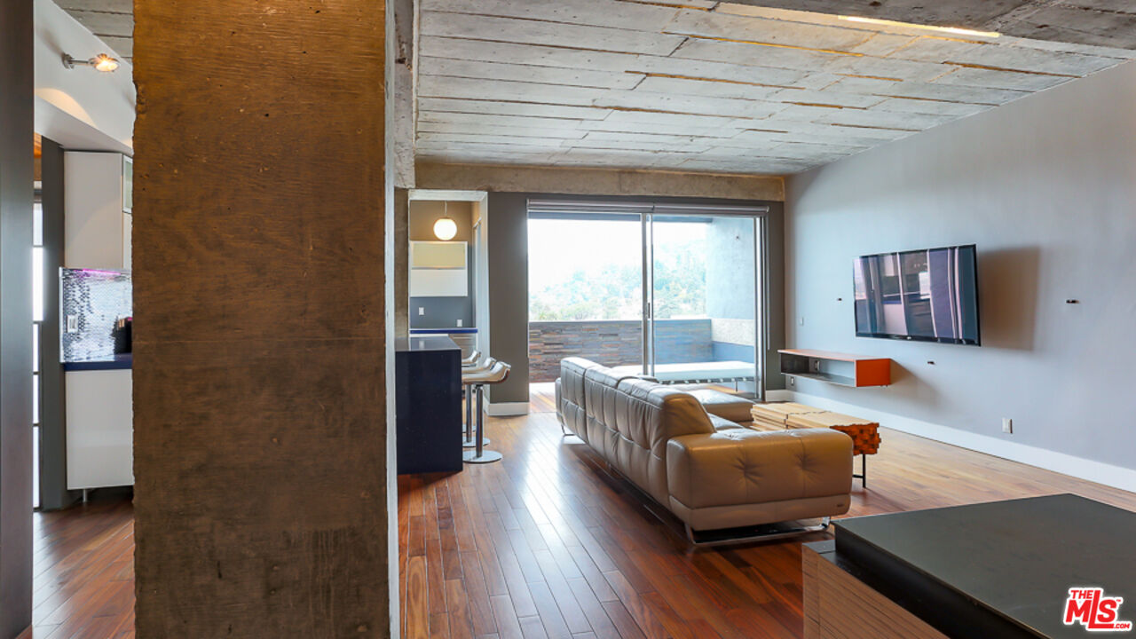 7250 Franklin Avenue, Unit 1112 Los Angeles, CA 90046 - Photo 4 of 29 a living room with furniture and a large window