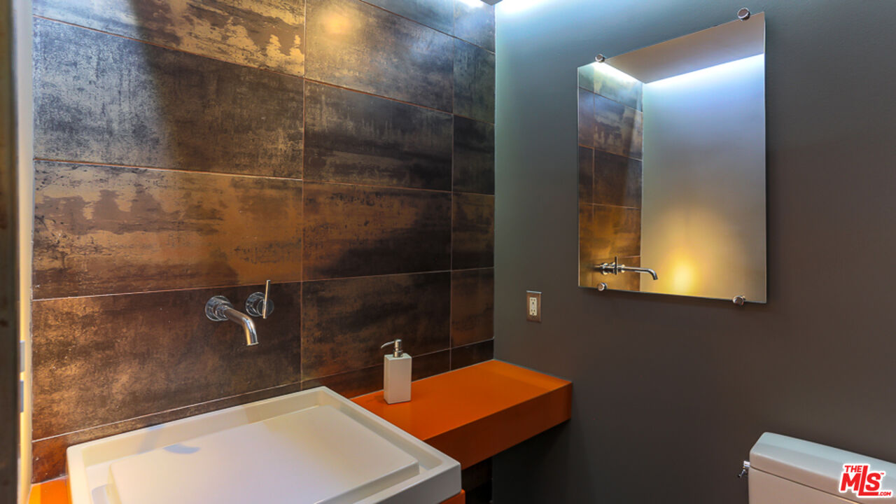 7250 Franklin Avenue, Unit 1112 Los Angeles, CA 90046 - Photo 8 of 29 a bathroom with a sink and a mirror