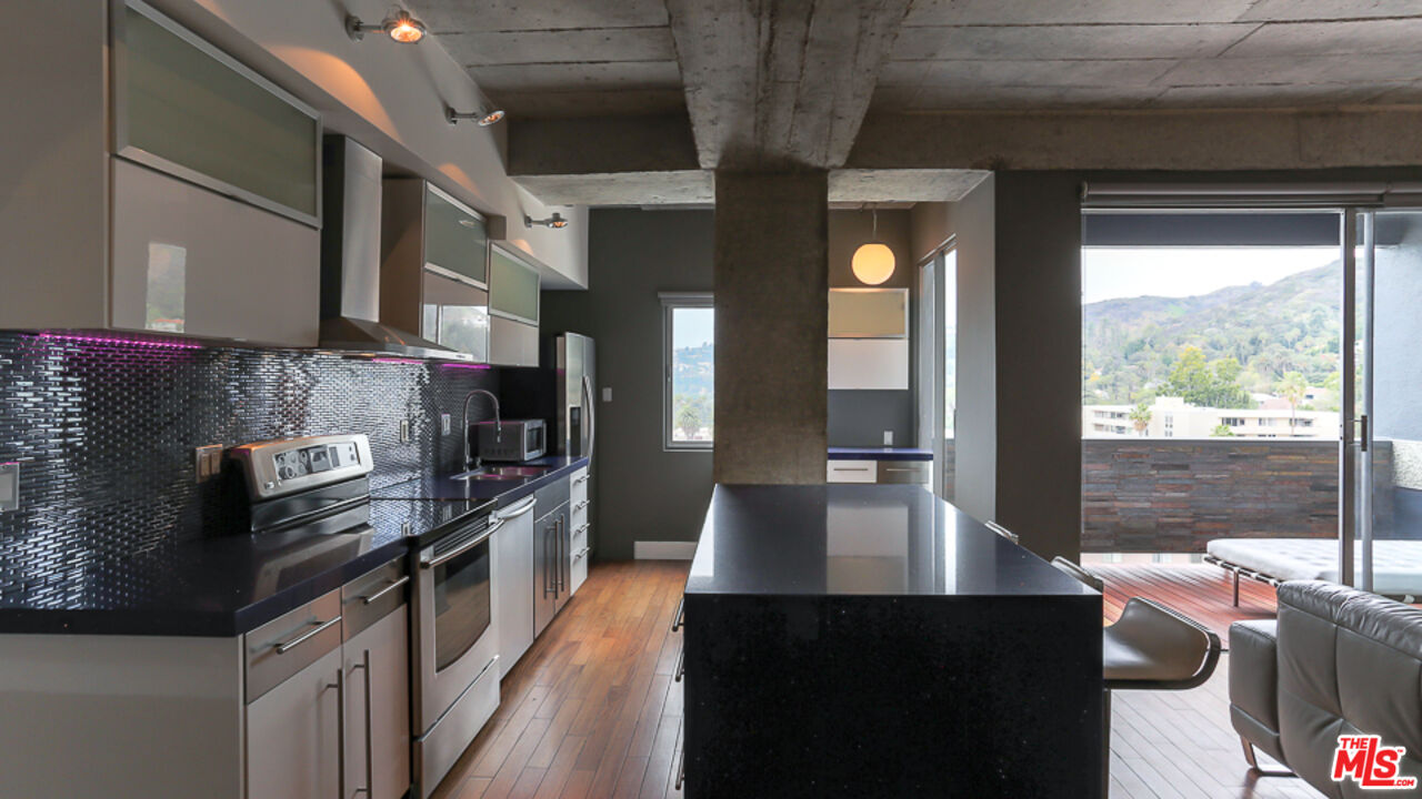 7250 Franklin Avenue, Unit 1112 Los Angeles, CA 90046 - Photo 10 of 29 a kitchen with stainless steel appliances granite countertop a sink a stove and a refrigerator