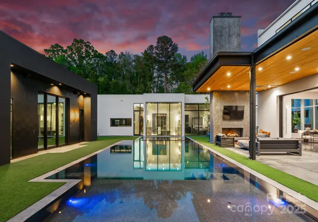 a view of house with a swimming pool outdoor seating