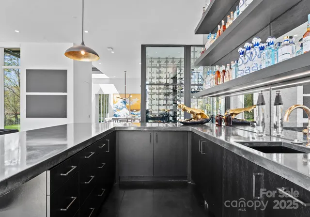 a kitchen with stainless steel appliances a sink and a large window