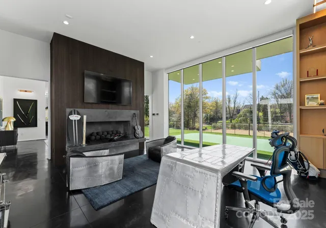 a living room with fireplace furniture and a flat screen tv