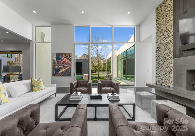 a living room with furniture chandelier and a large window