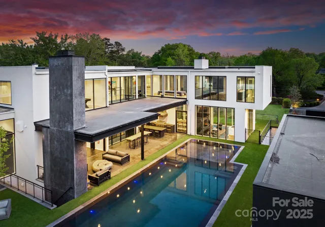 aerial view of a house with pool and chairs