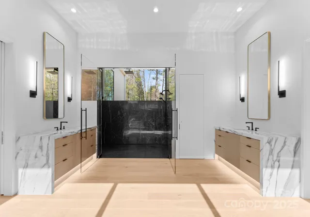 a spacious bathroom with a tub sink shower and mirror