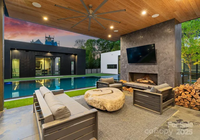 a outdoor living space with furniture and a flat screen tv