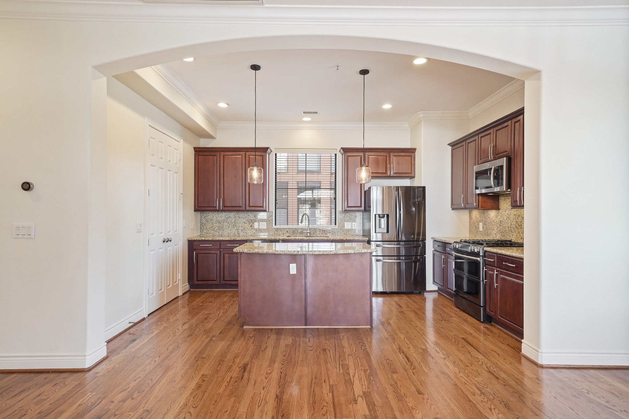 1402 Wheeler Avenue Houston, TX 77004 - Photo 13 of 40 a kitchen with stainless steel appliances granite countertop a refrigerator a sink dishwasher a stove with wooden floors