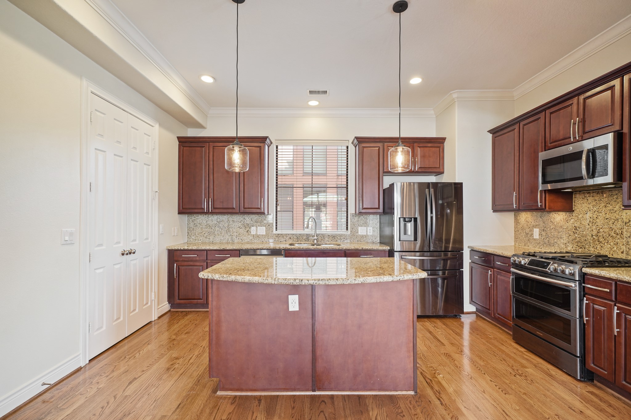 1402 Wheeler Avenue Houston, TX 77004 - Photo 14 of 40 a large kitchen with kitchen island a large counter top stainless steel appliances and cabinets