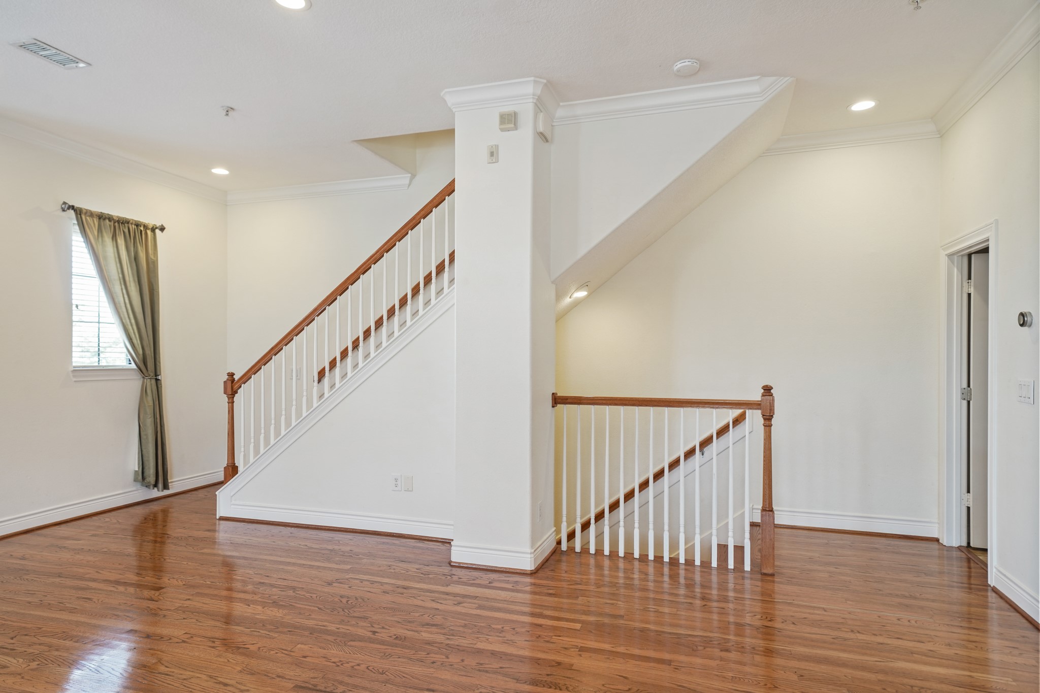 1402 Wheeler Avenue Houston, TX 77004 - Photo 18 of 40 a view of staircase with wooden floor and fan