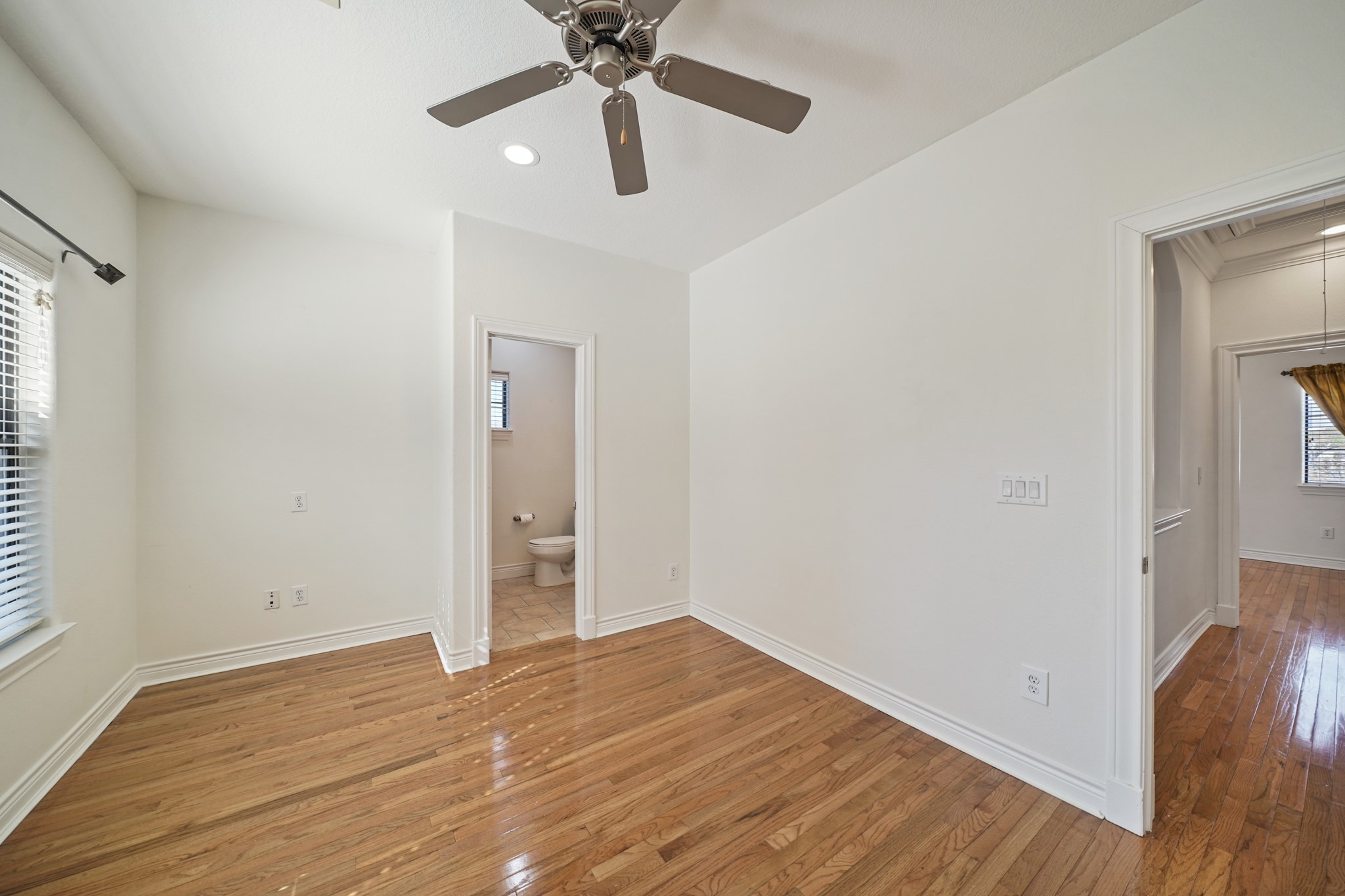 1402 Wheeler Avenue Houston, TX 77004 - Photo 30 of 40 an empty room with wooden floor a ceiling fan and entryway