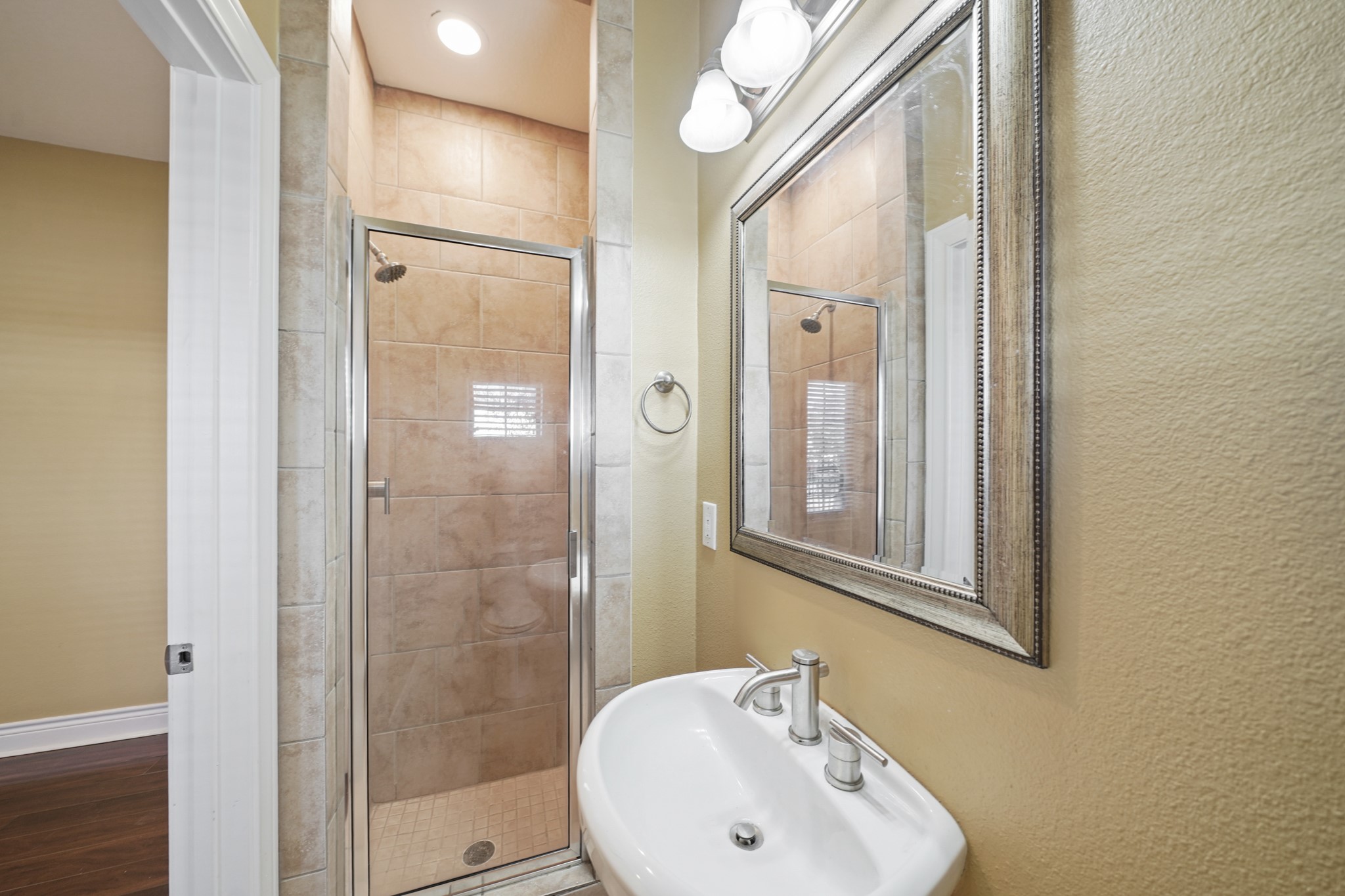 1402 Wheeler Avenue Houston, TX 77004 - Photo 35 of 40 a bathroom with a sink a mirror a glass door and shower