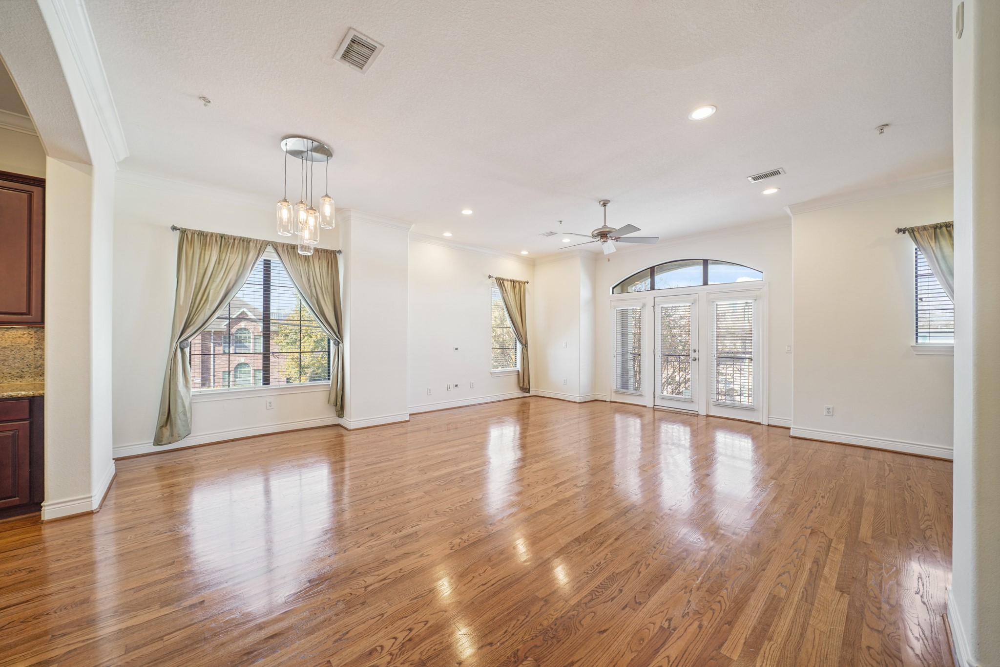 1402 Wheeler Avenue Houston, TX 77004 - Photo 5 of 40 a view of an empty room with wooden floor and a window