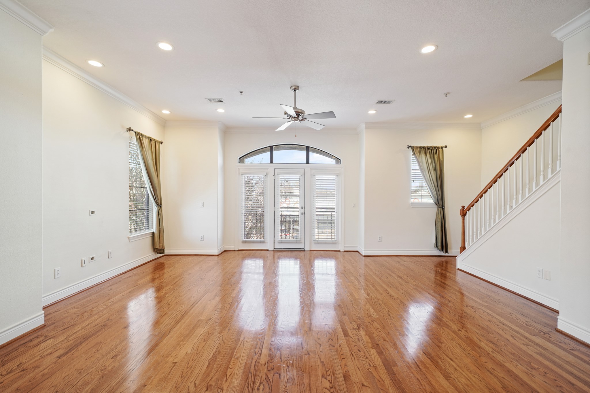 1402 Wheeler Avenue Houston, TX 77004 - Photo 6 of 40 a view of an empty room with wooden floor and a window