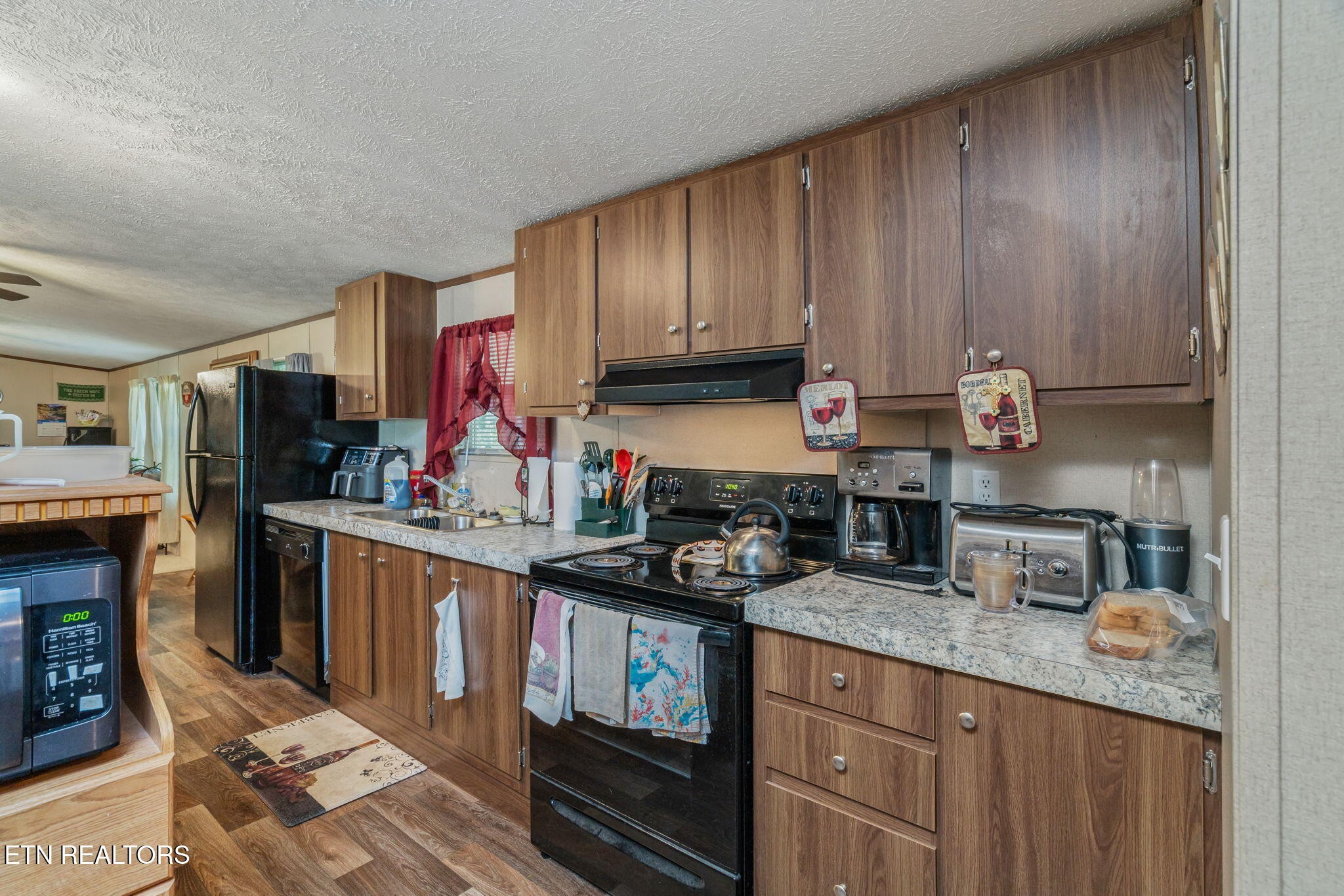 20156 Steekee Road Loudon, TN 37774 - Photo 17 of 46 a kitchen with granite countertop stainless steel appliances a stove top oven a sink and dishwasher