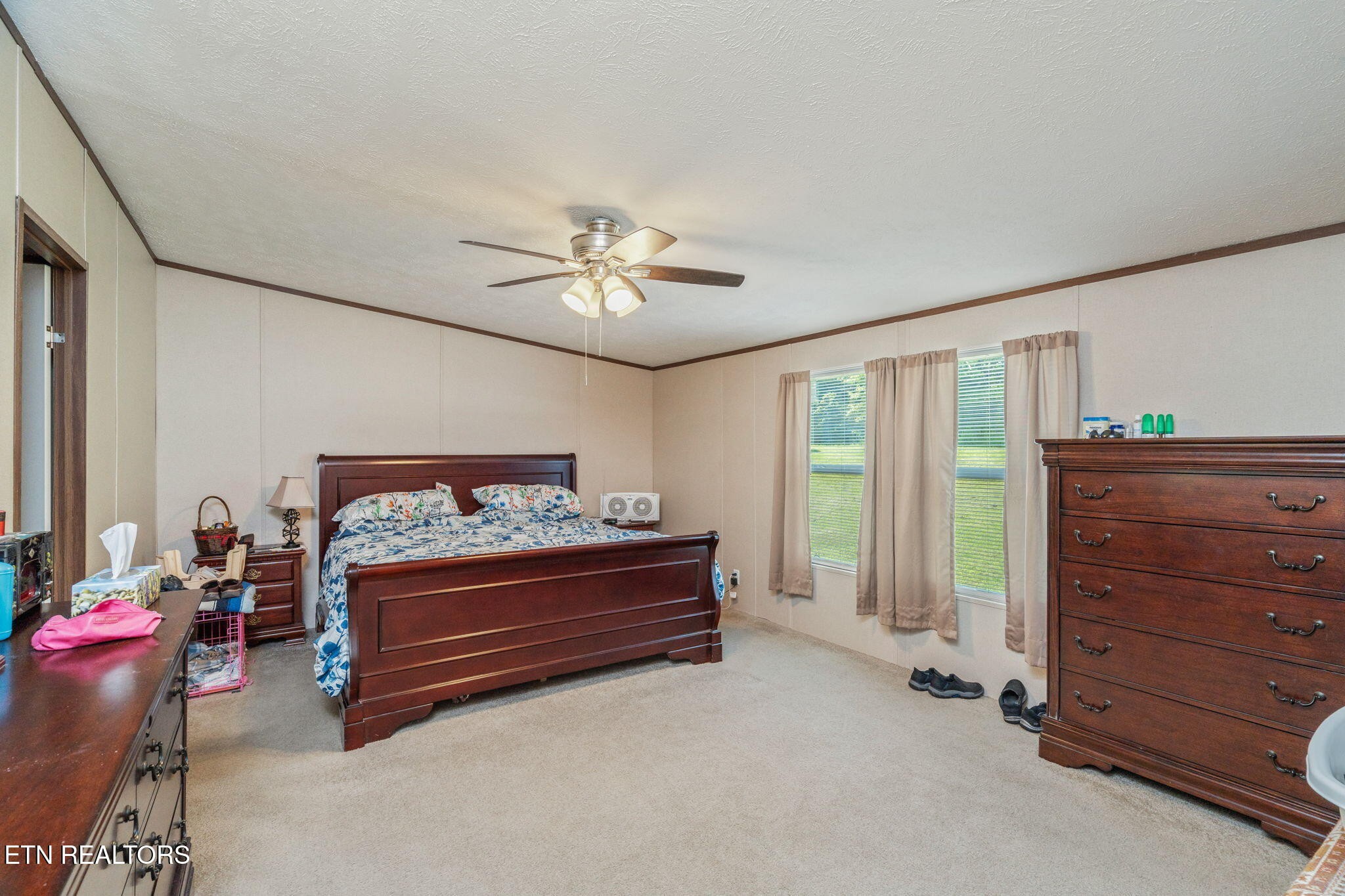 20156 Steekee Road Loudon, TN 37774 - Photo 19 of 46 a bedroom with a bed and a chandelier