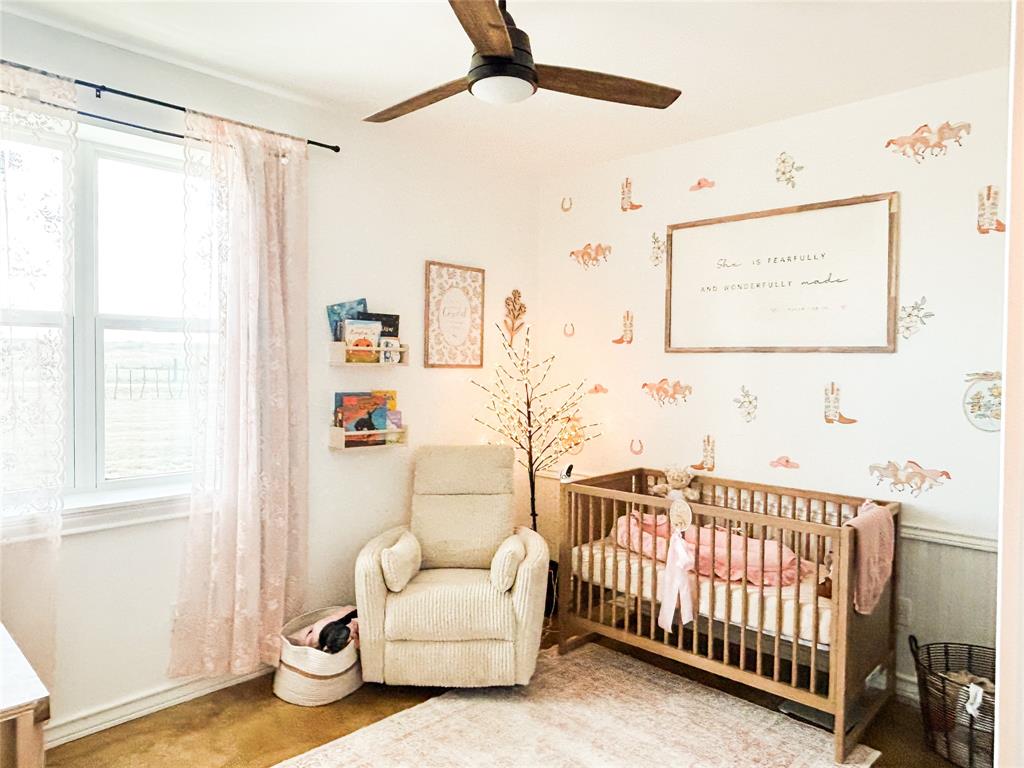925 Clear Spring Road Stephenville, TX 76401 - Photo 15 of 26 a bedroom with furniture and a window