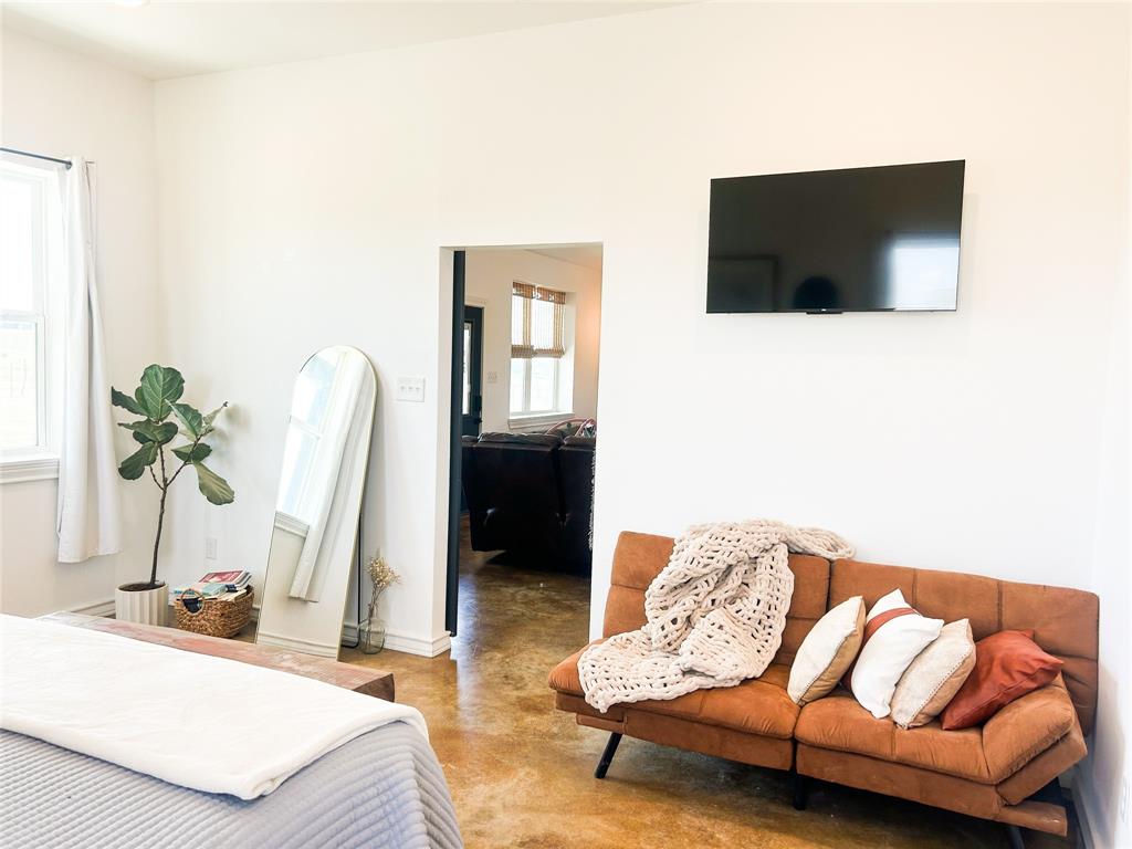 925 Clear Spring Road Stephenville, TX 76401 - Photo 2 of 26 a living room with furniture and a flat screen tv