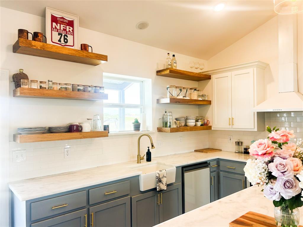 925 Clear Spring Road Stephenville, TX 76401 - Photo 4 of 26 a kitchen with a sink a stove and cabinets