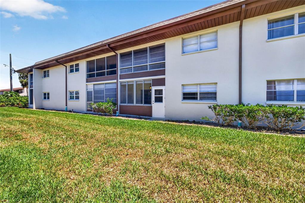 5197 Silent Loop, Unit 124 New Port Richey, FL 34652 - Photo 36 of 55 a view of a house with backyard and garden