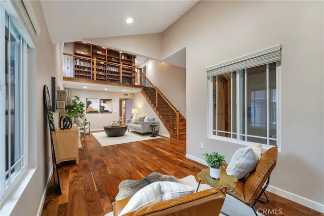 a view of a hallway with wooden floor and staircase