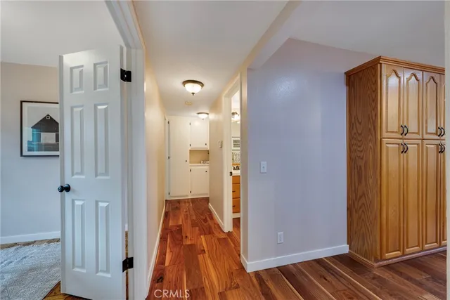 a view of a livingroom with a hall and a ceiling fan
