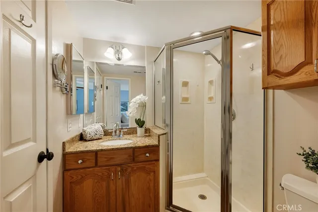 a kitchen with stainless steel appliances kitchen island granite countertop a table chairs in it and wooden floors