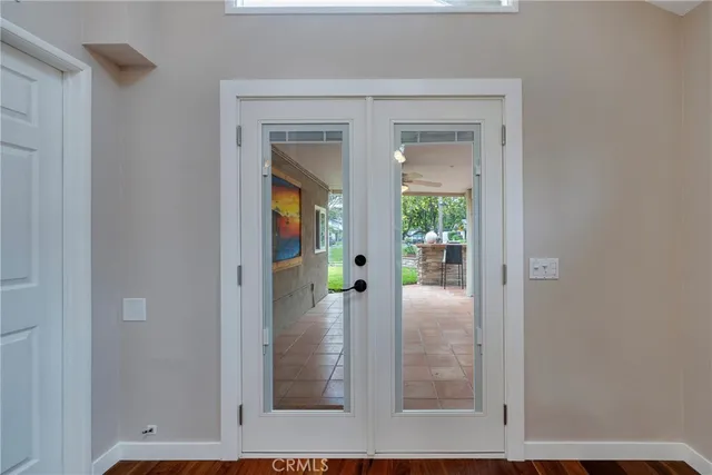 a view of a hallway with wooden floor and entryway