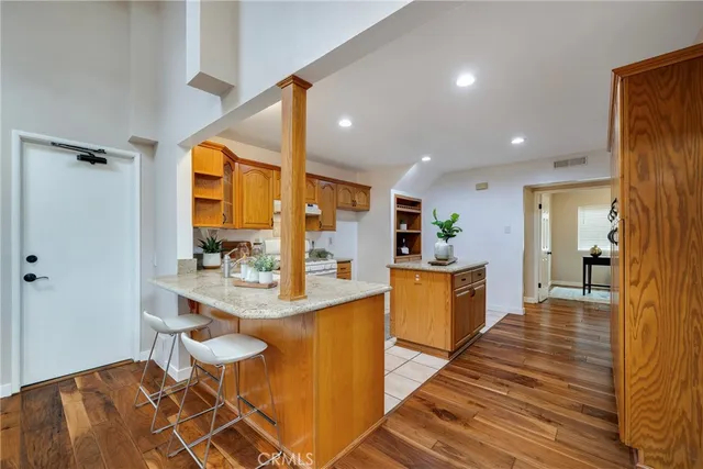 a view of a hallway with wooden floor and closet area