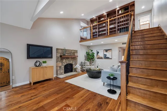 a view of a kitchen area with furniture and wooden floor