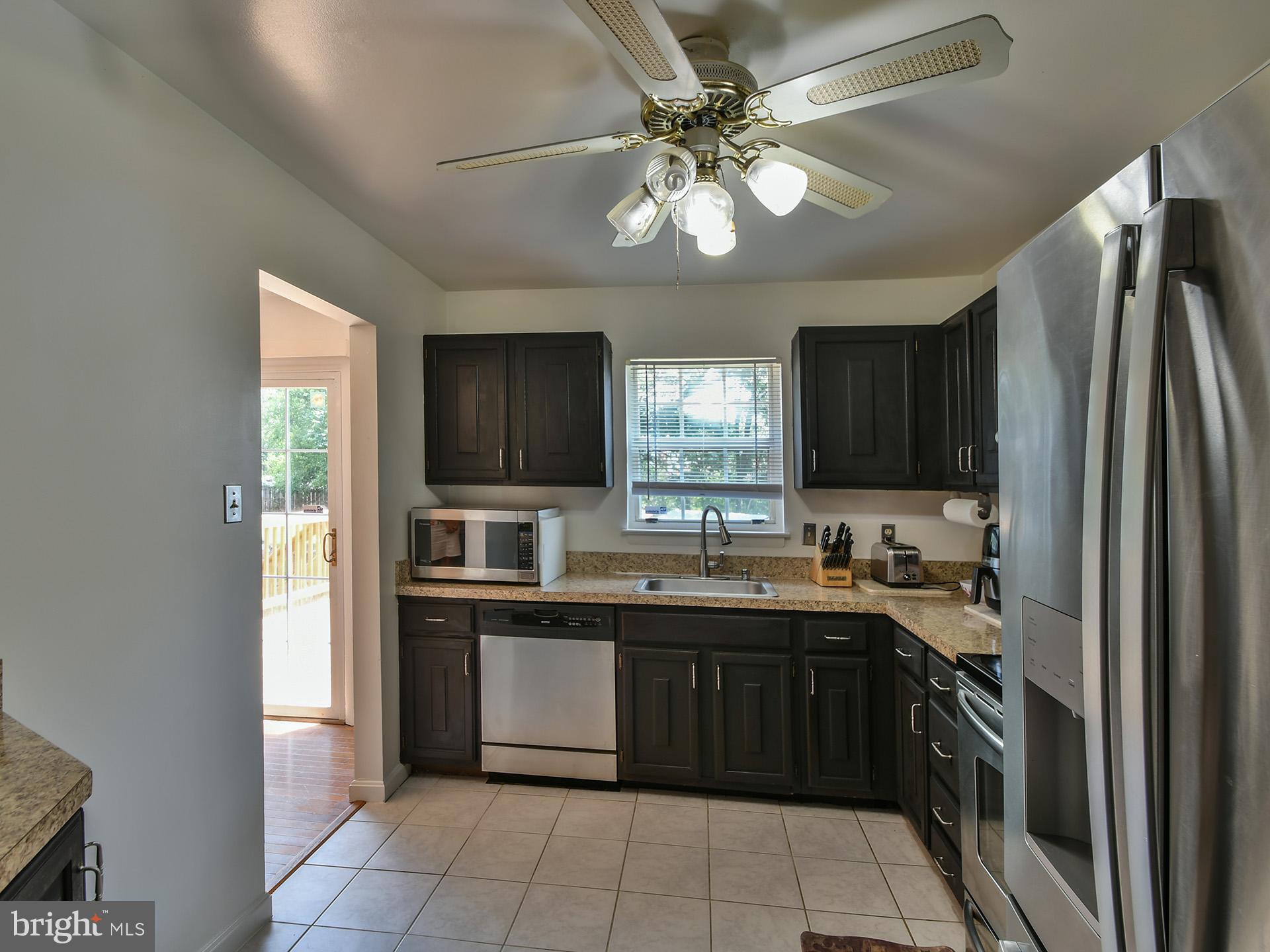 8600 Sumter Lane Clinton, MD 20735 - Photo 12 of 51 a kitchen with stainless steel appliances granite countertop a sink stove and refrigerator