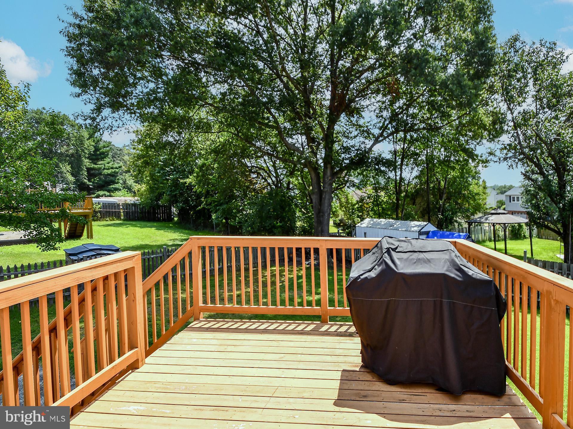 8600 Sumter Lane Clinton, MD 20735 - Photo 7 of 51 a view of a wooden deck and trees with wooden fence