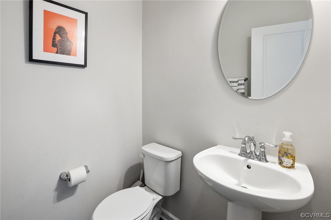 5419 Sandy Ridge Terrace Chesterfield, VA 23832 - Photo 13 of 27 a bathroom with a toilet a sink and a mirror