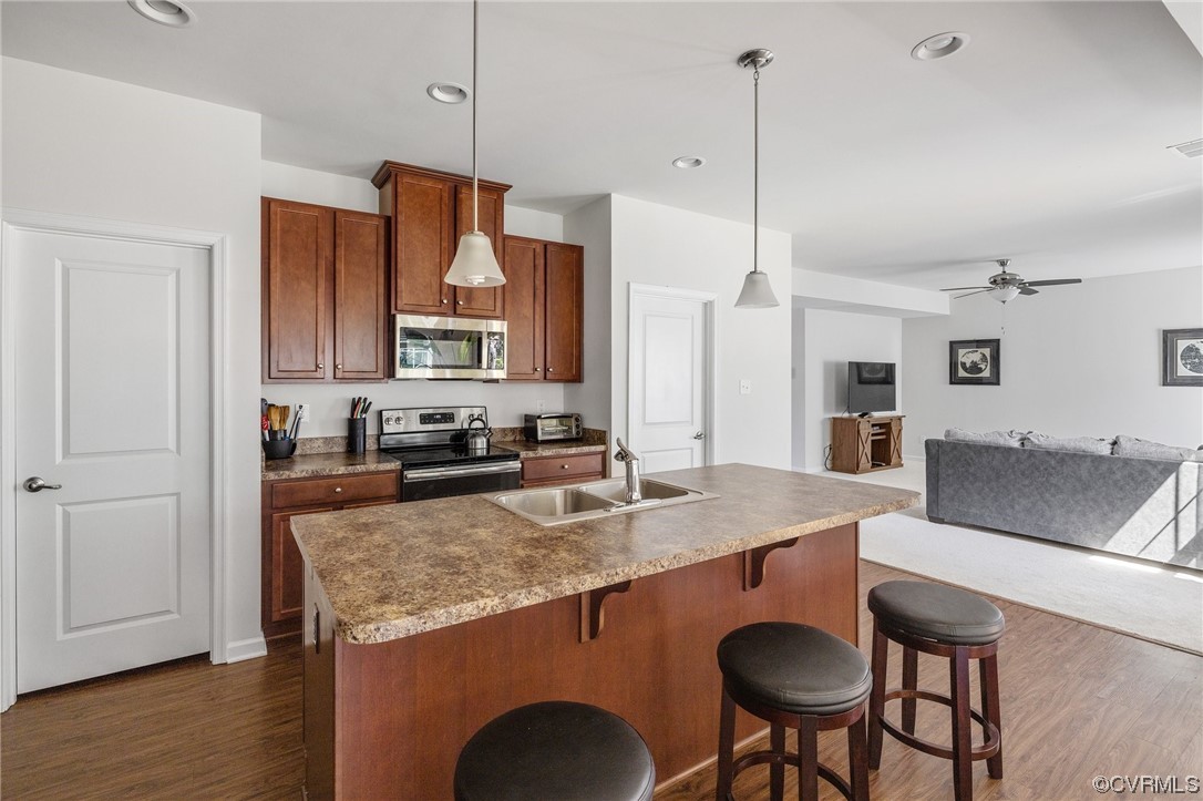 5419 Sandy Ridge Terrace Chesterfield, VA 23832 - Photo 8 of 27 a kitchen with granite countertop a table chairs microwave and sink