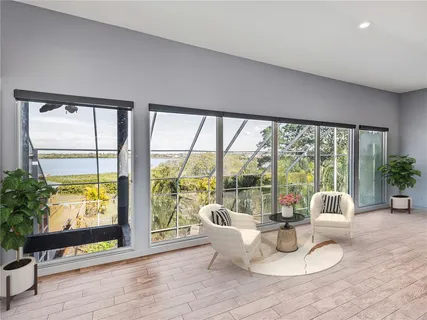 a kitchen with stainless steel appliances kitchen island granite countertop a dining table chairs refrigerator and sink