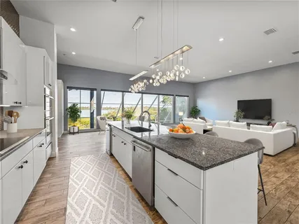 a bathroom with a toilet a sink and wooden floor