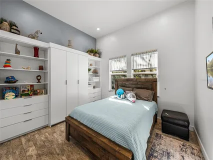 a bedroom with a bed and a view of kitchen