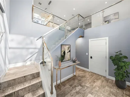 a living room with furniture a flat screen tv and a wooden floor