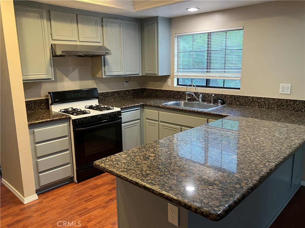 19933 Ralph Street Walnut, CA 91789 - Photo 19 of 77 a kitchen with stainless steel appliances granite countertop a sink stove and cabinets