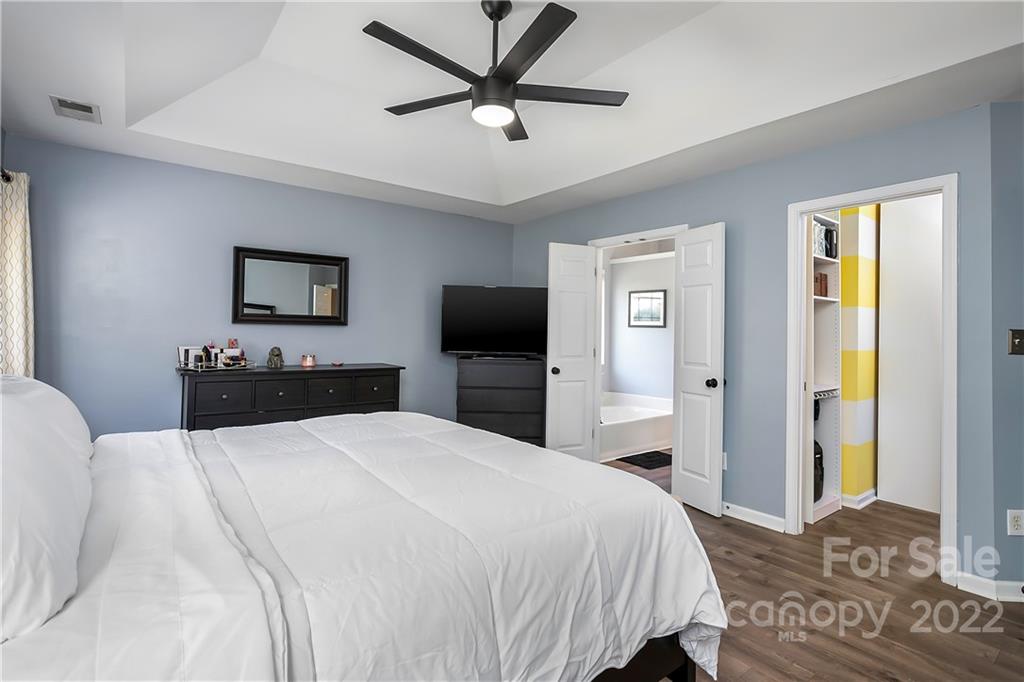7601 Silverton Way Huntersville, NC 28078 - Photo 13 of 26 a bedroom with a bed and a flat tv screen on dresser