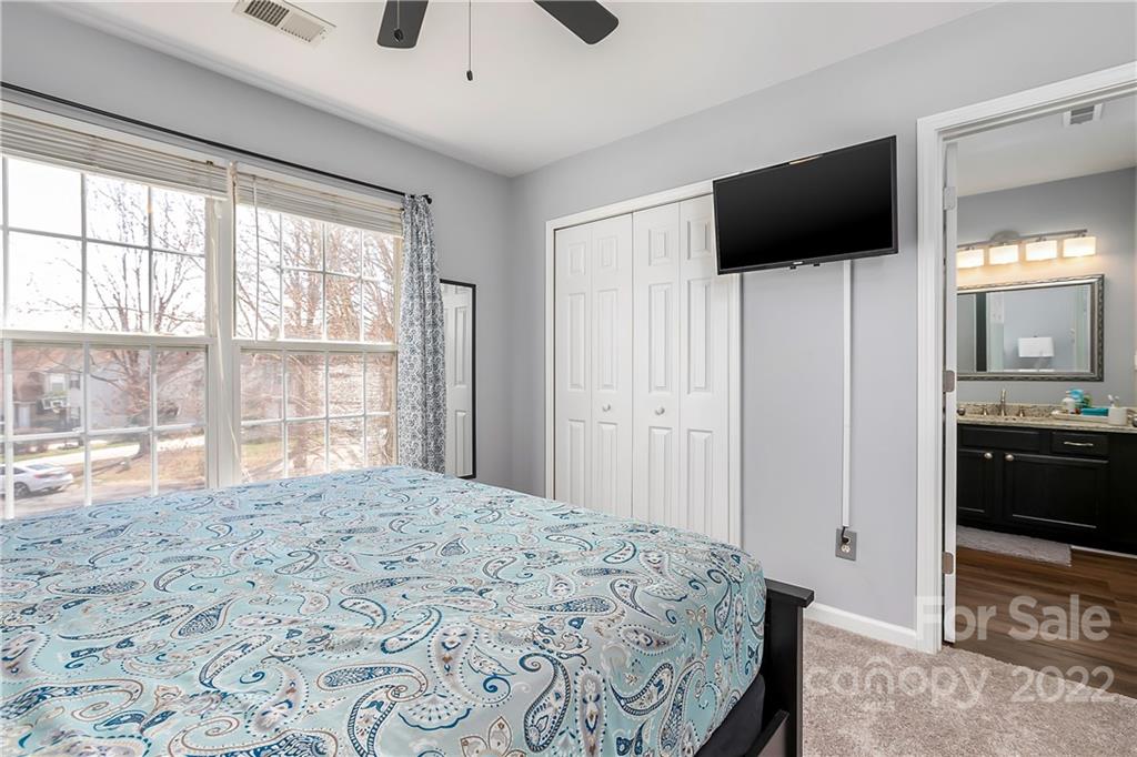 7601 Silverton Way Huntersville, NC 28078 - Photo 17 of 26 a bedroom with a bed and a flat screen tv