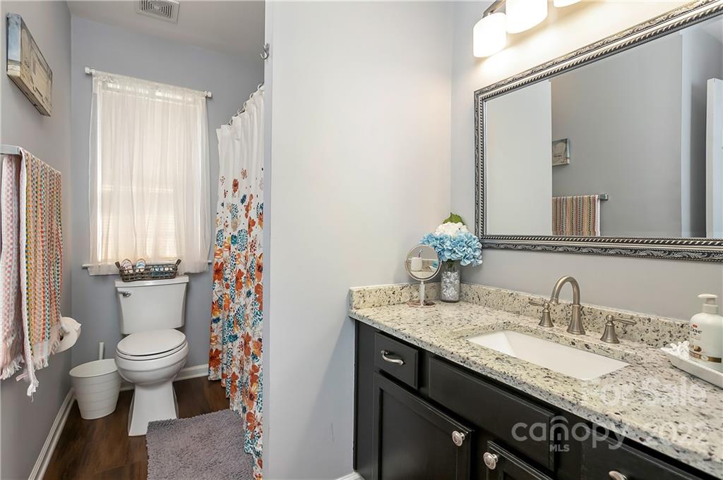 7601 Silverton Way Huntersville, NC 28078 - Photo 19 of 26 a bathroom with a granite countertop sink and a mirror