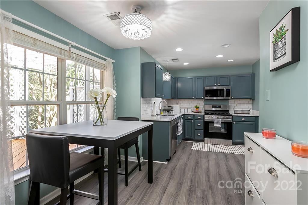 7601 Silverton Way Huntersville, NC 28078 - Photo 7 of 26 a kitchen with a table chairs stove and cabinets