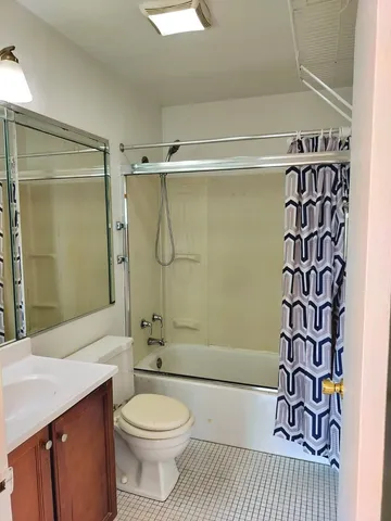 a bathroom with a shower toilet and sink